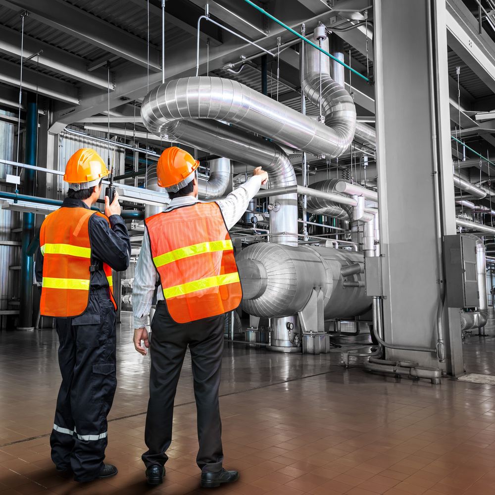 NEX Lubricants technicians inspecting industrial equipment